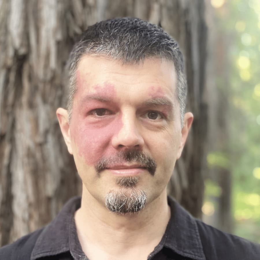 Ryan McGladrey, standing in front of a redwood