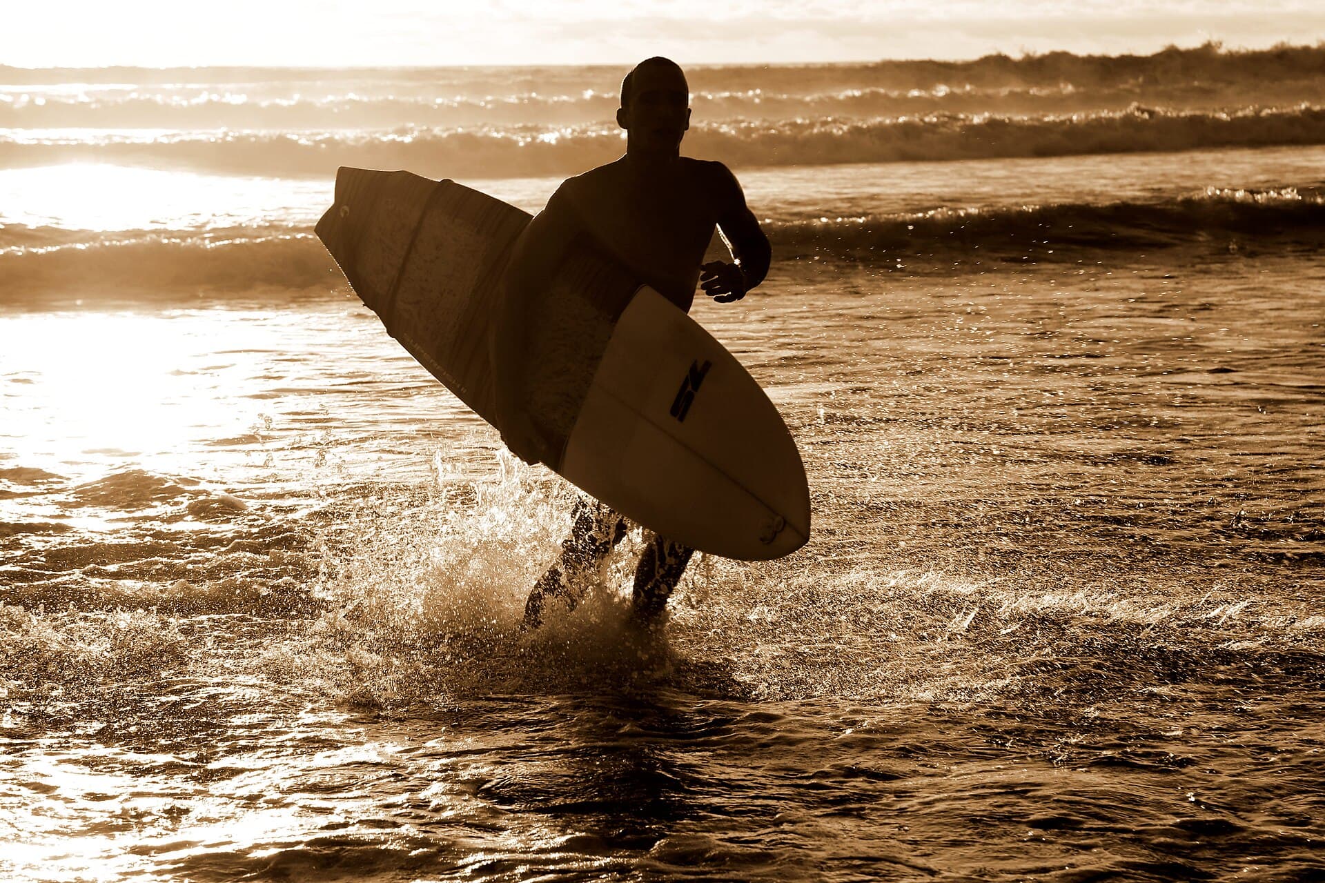 A surfer at sunset on a Costa Rica beach