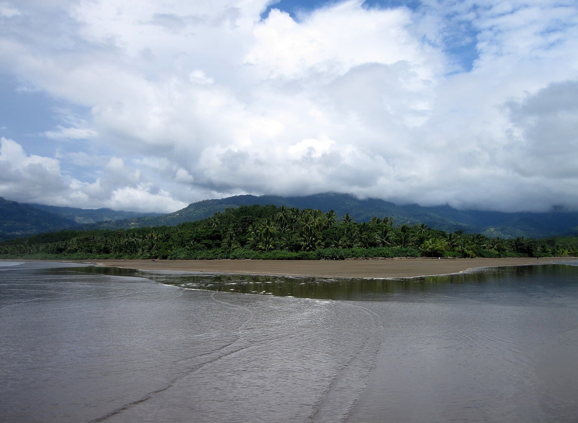 Low tide at Uvita beach, with the coastal mountains behind